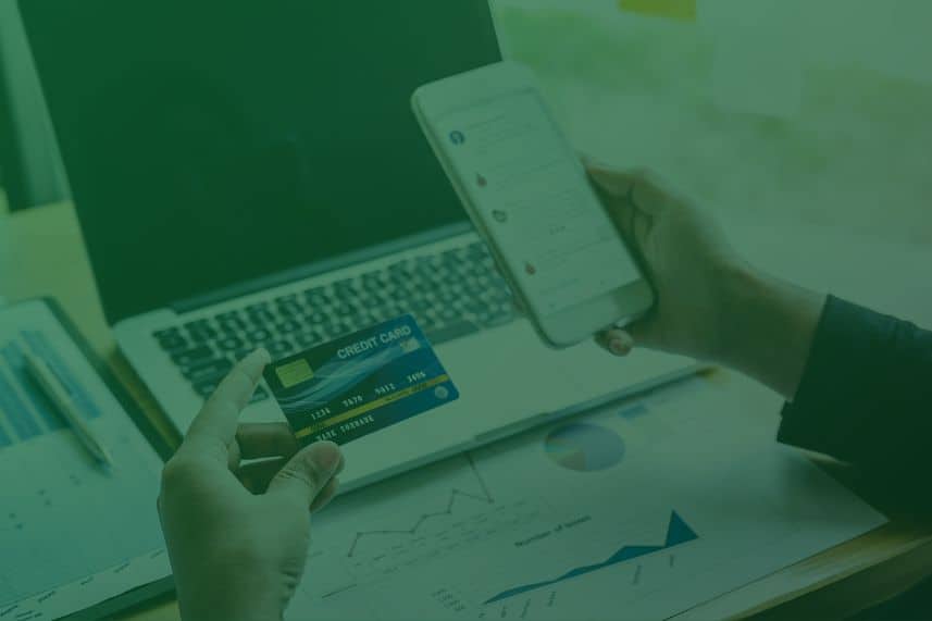 cover web blog 2 dompet dhuafa Gambar orang di depan laptop memegang gawai dan kartu debit sebagai ilustrasi membayar zakat penghasilan via online