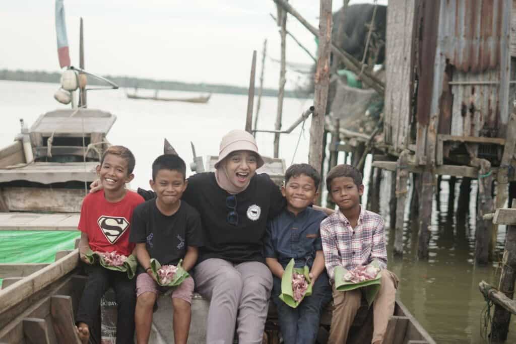 tebar hewan kurban di sumatra utara7 dompet dhuafa Ditemani oleh anak-anak desa, Chiki mengantarkan daging-daging kurban ke rumah-rumah warga Desa Jaring Halus menggunakan perahu kayu.