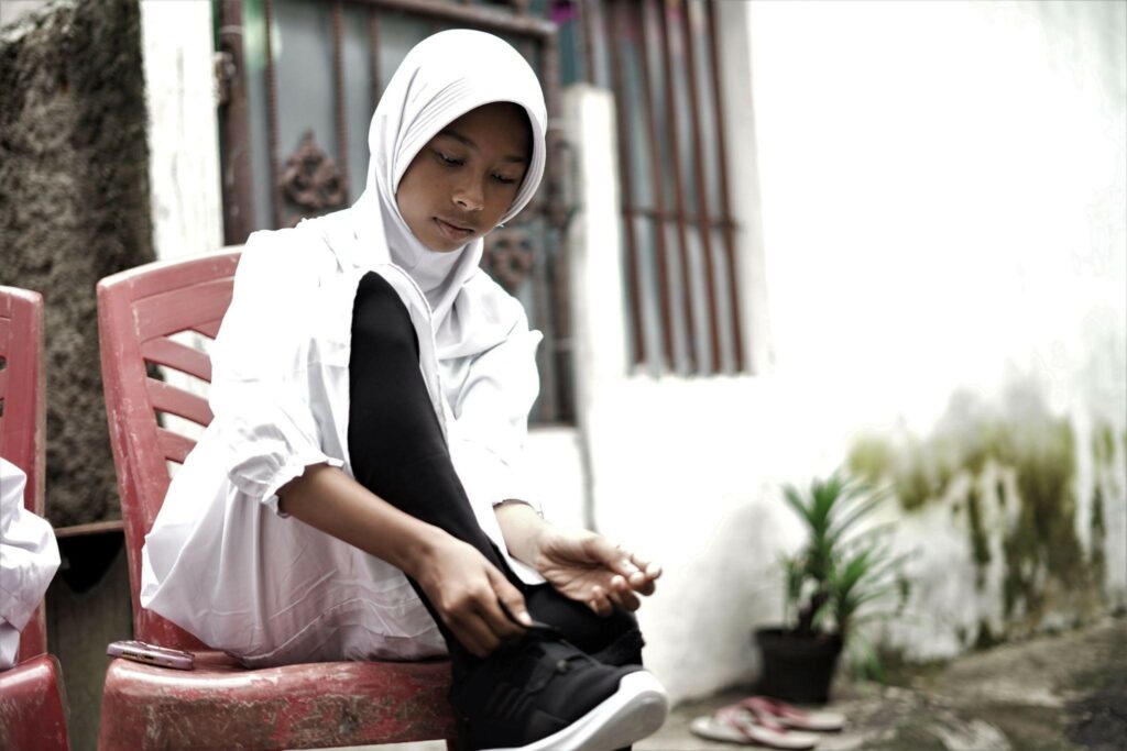 bantuan school kit5 dompet dhuafa Mutia saat menjajal mengenakan sepatu barunya yang akan ia gunakan untuk bersekolah.