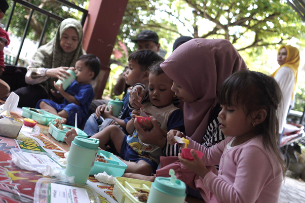 implementasi zakat dari humia trust3 dompet dhuafa Balita didampingi Ibunda menikmati makanan bergizi dari program Pos Gizi di Posyandu Mawar, Kelurahan Mangempang, Kabupaten Barru.