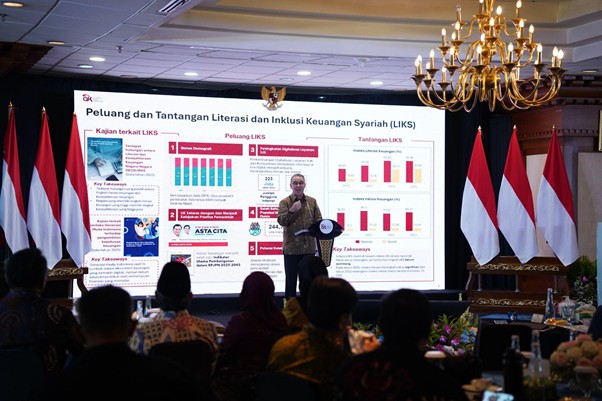 dampakzakatroisojkdandompetdhuafa20263 dompet dhuafa Speaker presenting a slide deck on a conference stage with Indonesian flags on the sides and an audience watching.