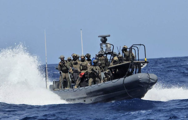 kapal global sumud flotilla dibajak israel 3 dompet dhuafa A squad of soldiers in tactical gear on a rigid inflatable boat speeding across the ocean.