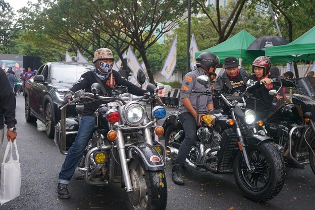 kurbanaval20262 dompet dhuafa Group of motorcyclists on custom bikes lined up at an outdoor event, with tents and spectators in the background.
