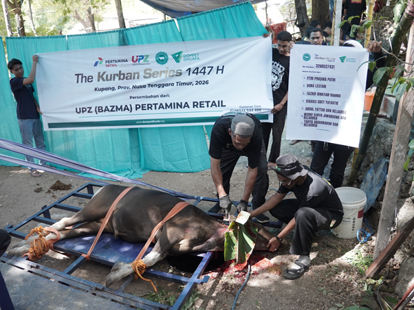 Group of men performing a cow sacrifice on a metal frame during Eid al-Adha, with banners reading 'The Kurban Series 1447 H' in the background.