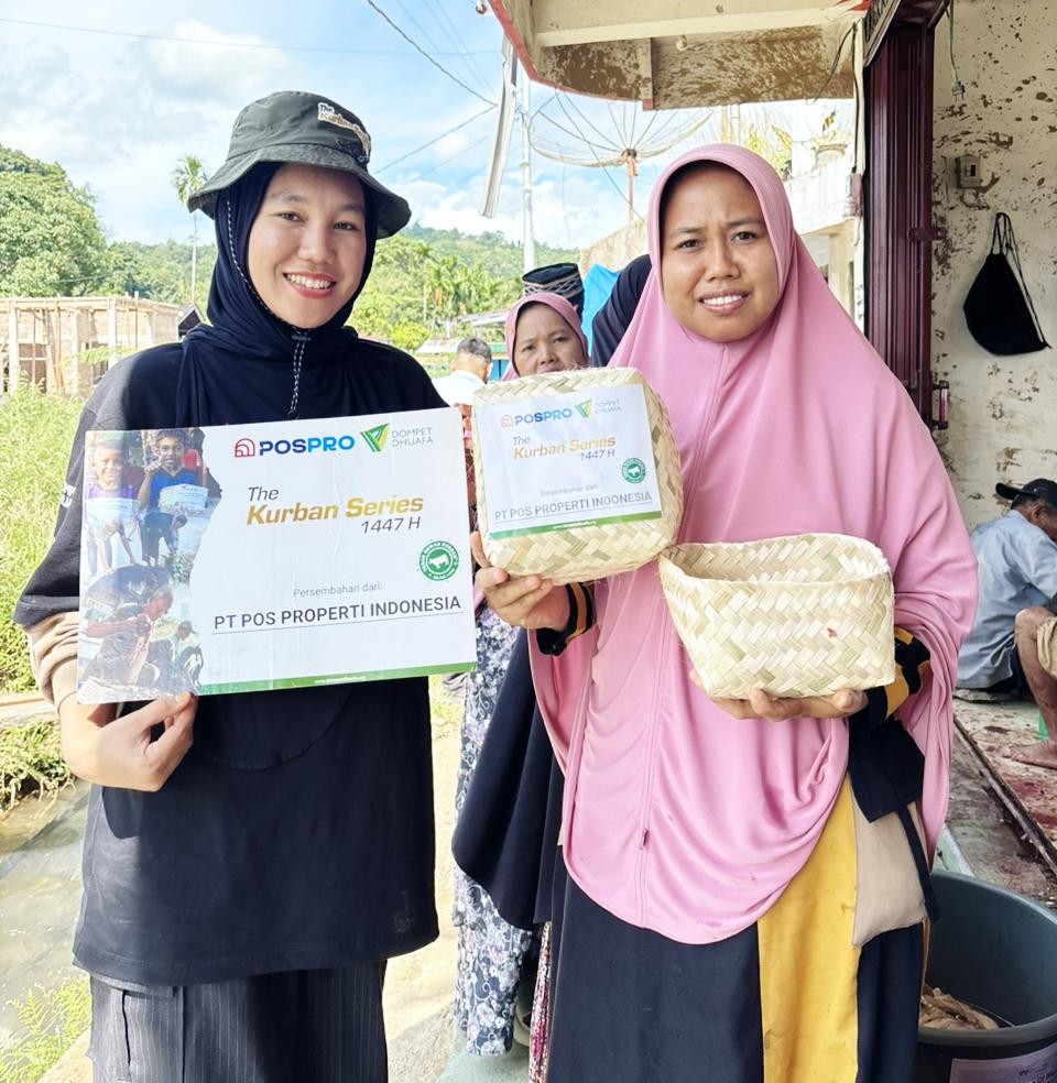 img20260604wa0006jpg dompet dhuafa Two women in hijabs hold donation items outdoors for The Kurban Series, smiling at the camera.