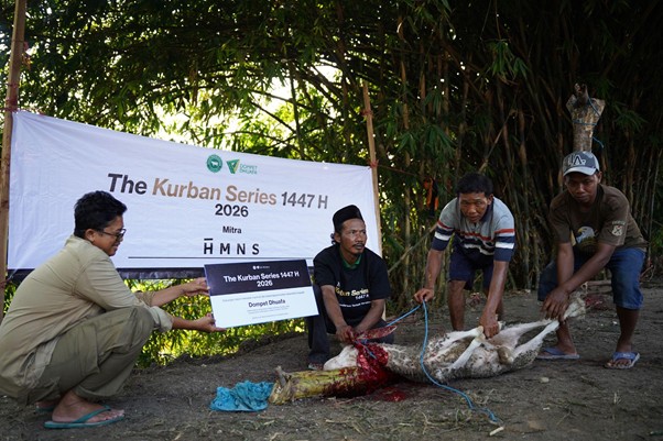 Four men prepare a sheep for Qurbani sacrifice beside a banner reading 'The Kurban Series 1447 H, 2026'.