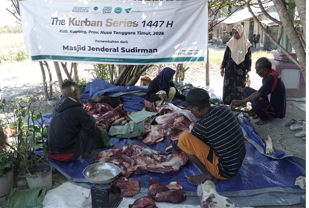 People processing and sorting meat on tarps under a banner for The Kurban Series 1447 H outside a mosque or community space.