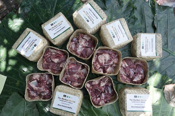 kurban di lampung timur 4 dompet dhuafa Woven baskets filled with sliced red meat arranged on large green leaves, each with a labeled tag reading 'The Kurban Series'.