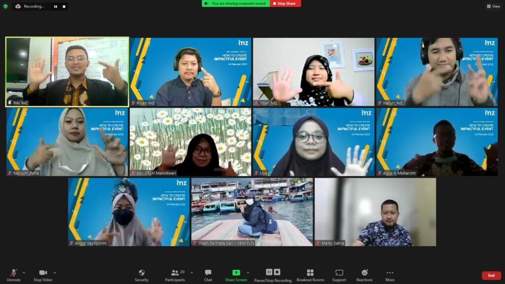 photo20220225150635 dompet dhuafa Twelve participants in a Zoom video conference grid, many raising their hands in greeting or agreement.