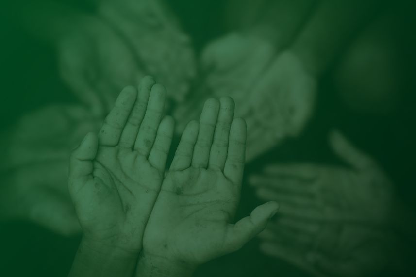 keluarga menyantuni anak yatim dompet dhuafa Hands held up in a gesture of greeting or support, muddy palms visible; blurred group in the background.