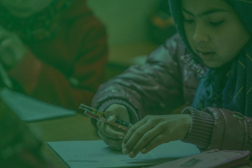 masa depan anak yatim dompet dhuafa Young student wearing a hijab in a classroom, using a syringe-like tool while working on a worksheet.