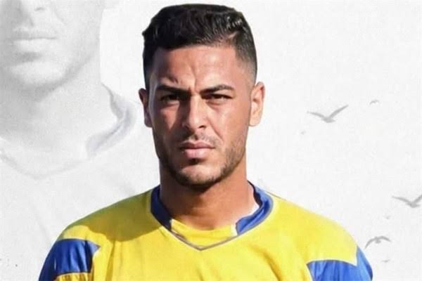 saleem khader kiper palestina dompet dhuafa Portrait of a man in a yellow and blue sports jersey facing the camera with a neutral, serious expression.